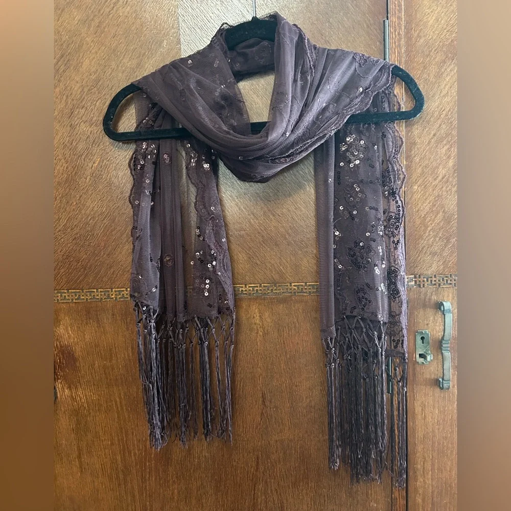 Sheer sequin embellished evening shawl or wrap with fringe tassels. Wine color